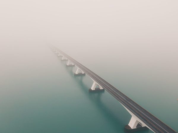 A beautiful shot of the Zeeland bridge covered with fog in the Netherlands
